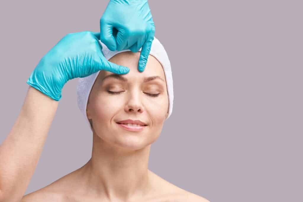 Older woman having a consultation with her surgeon about brow lift guidance and recovery