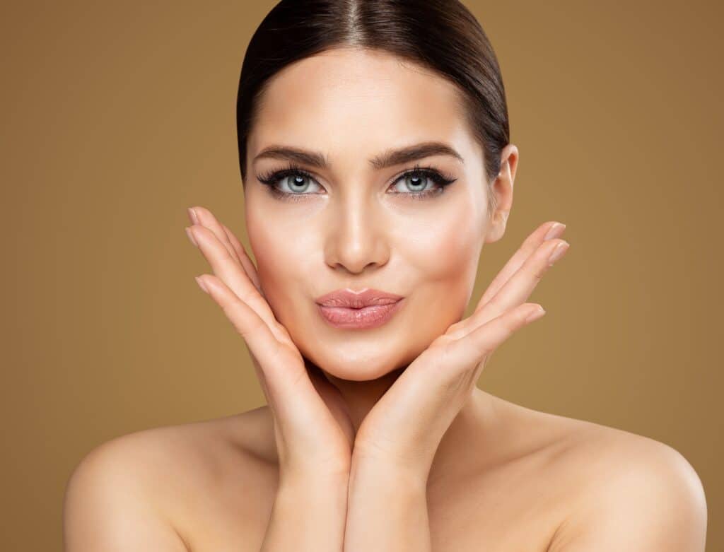 Woman pursing her lips to show off her lip lift to enhance the results of her facelift