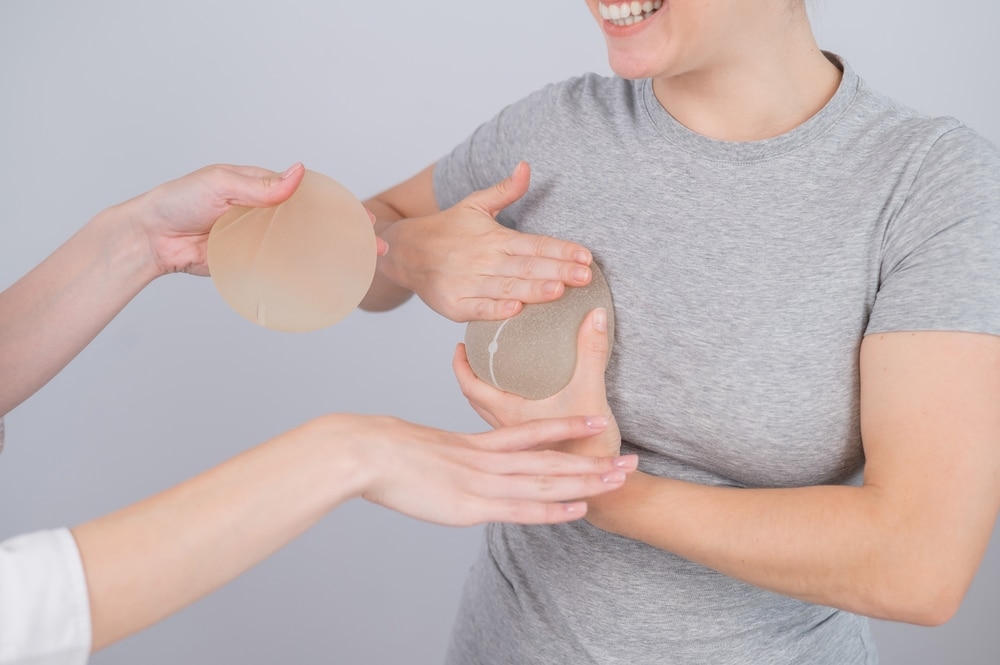 Happy woman having a consultation with her plastic surgeon before breast augmentation.
